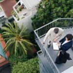 Finance department manager showing annual report to his colleagues, view from the top